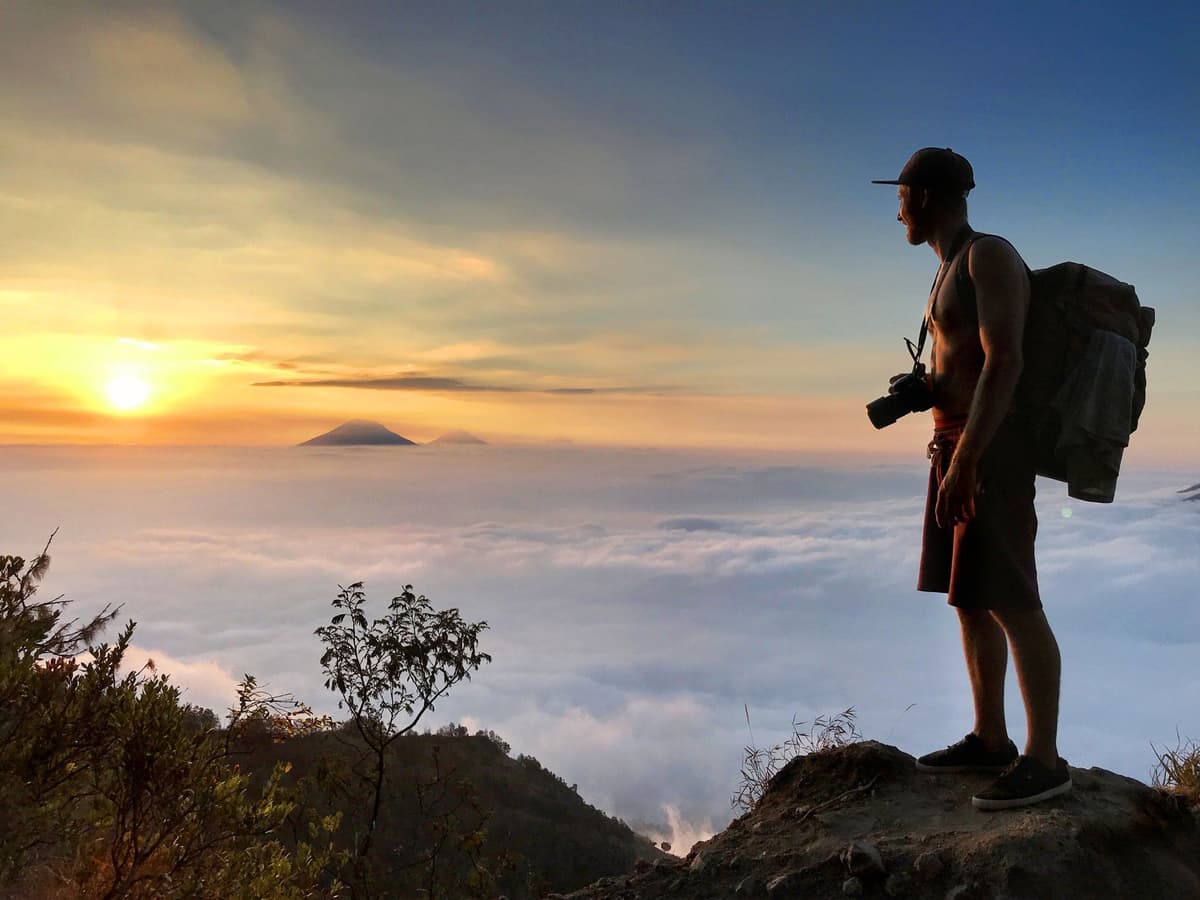 A hiker watching the sunrise on Mount Batur.