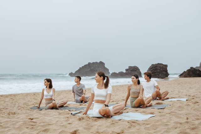 A yoga group on a sunset beach