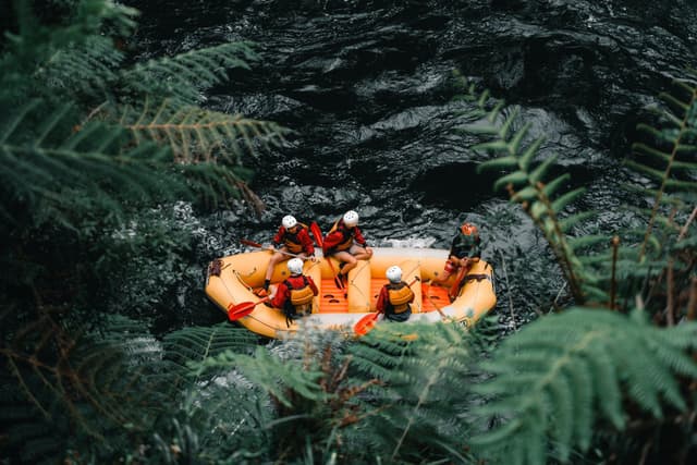 People rafting through lush jungle rivers