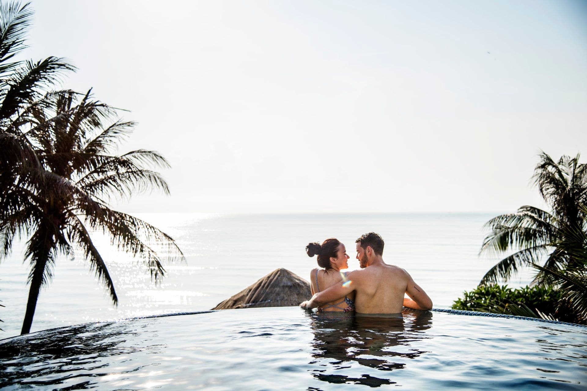 A couple enjoying a private villa with an infinity pool