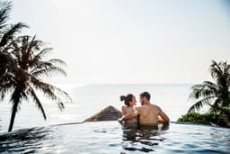 A couple enjoying a private villa with an infinity pool